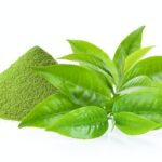 green tea leaf and matcha green tea powde on white background